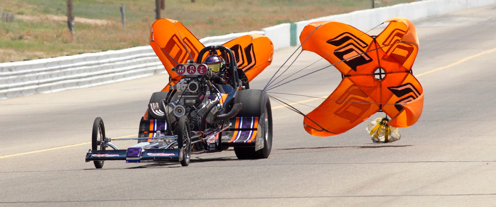 The Cone Killer slowing down under orange parachutes